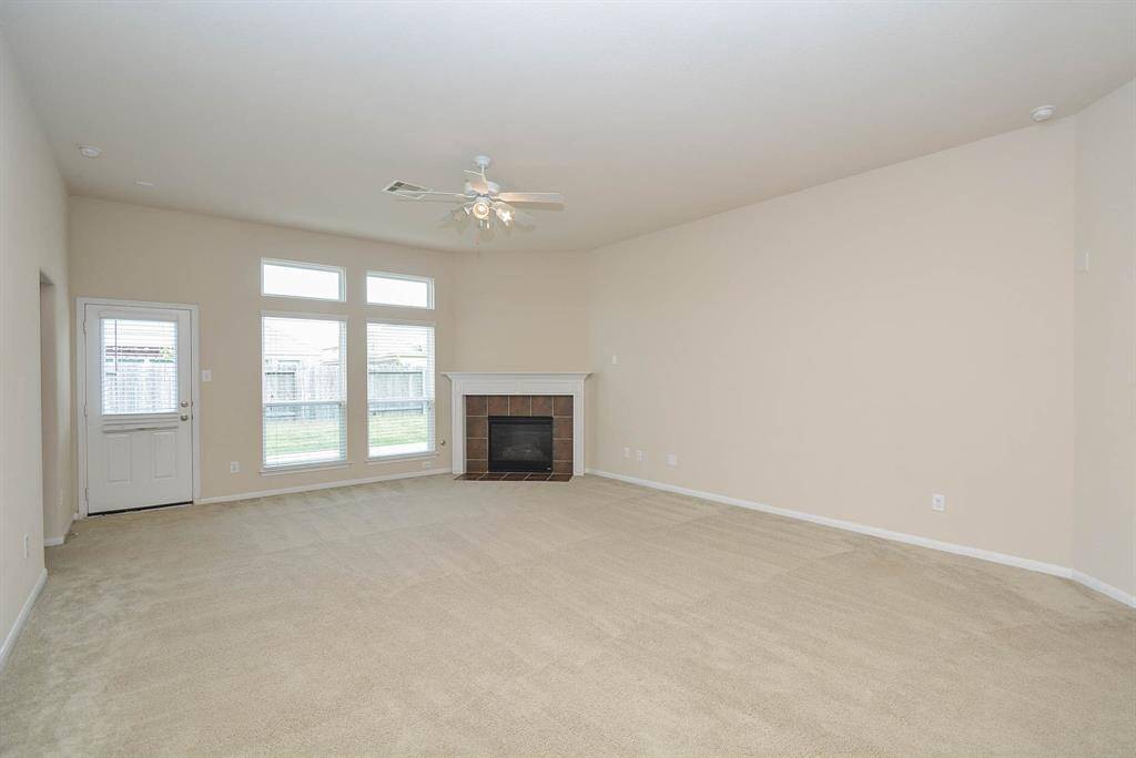 The main living room is large with a nice gas log fireplace and lots of natural lighting.