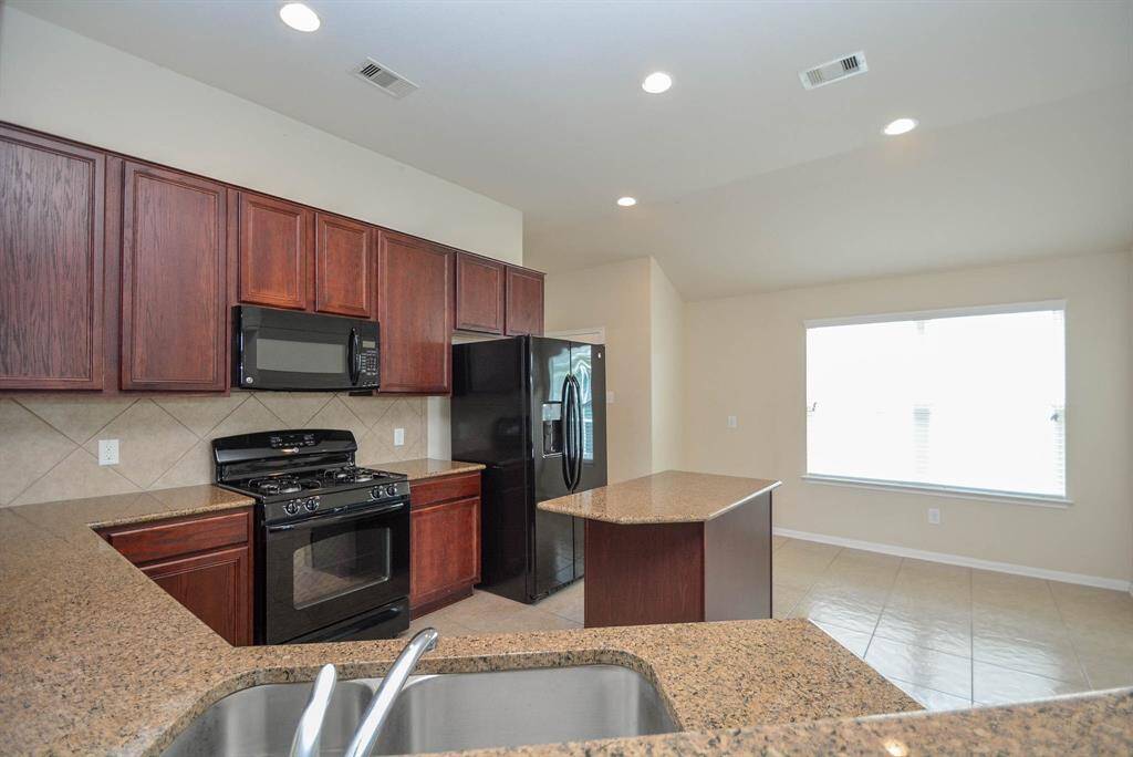 The spacious island kitchen with granite countertops offers a great space to prepare those meals for the family.