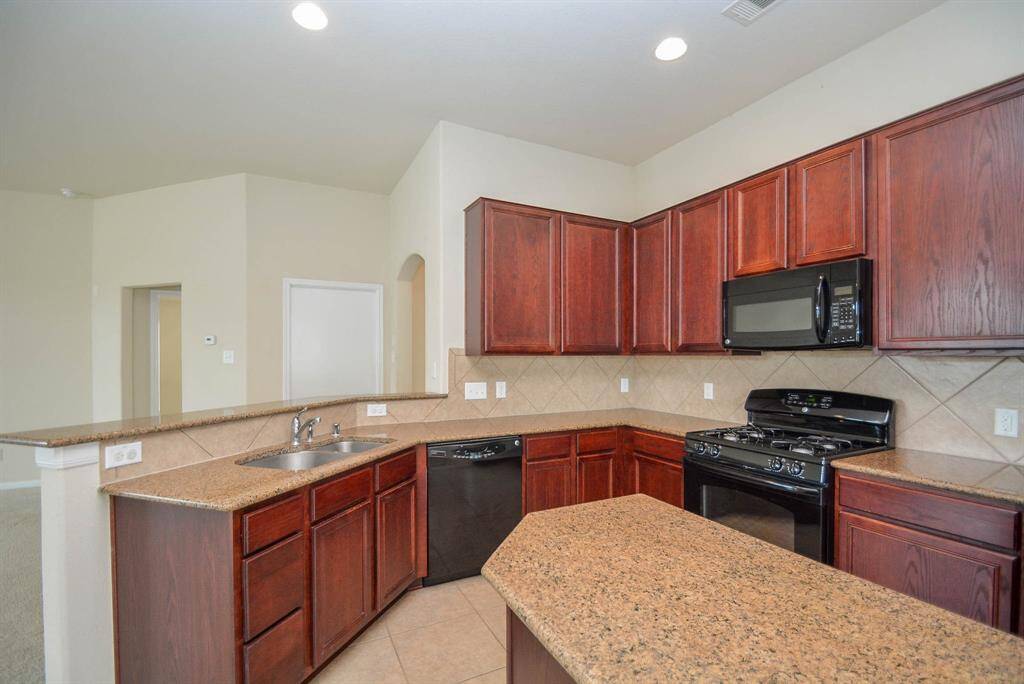 The kitchen opens up to the main living area and it includes a nice bar top for entertaining.