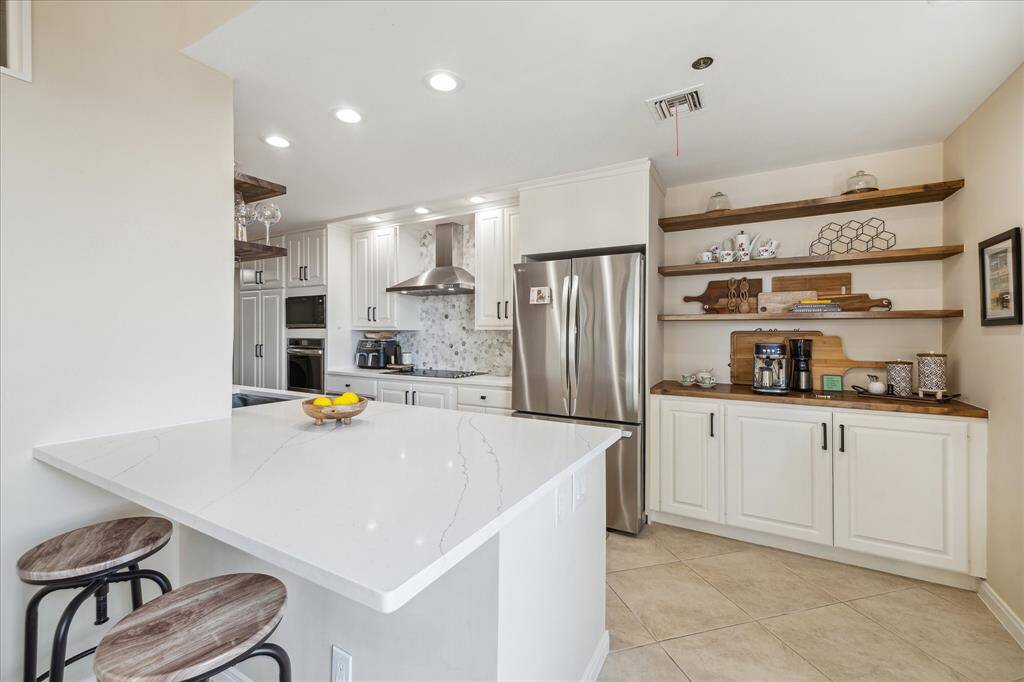 Large primary bedroom with sitting area and two nice sized walk-in closets.