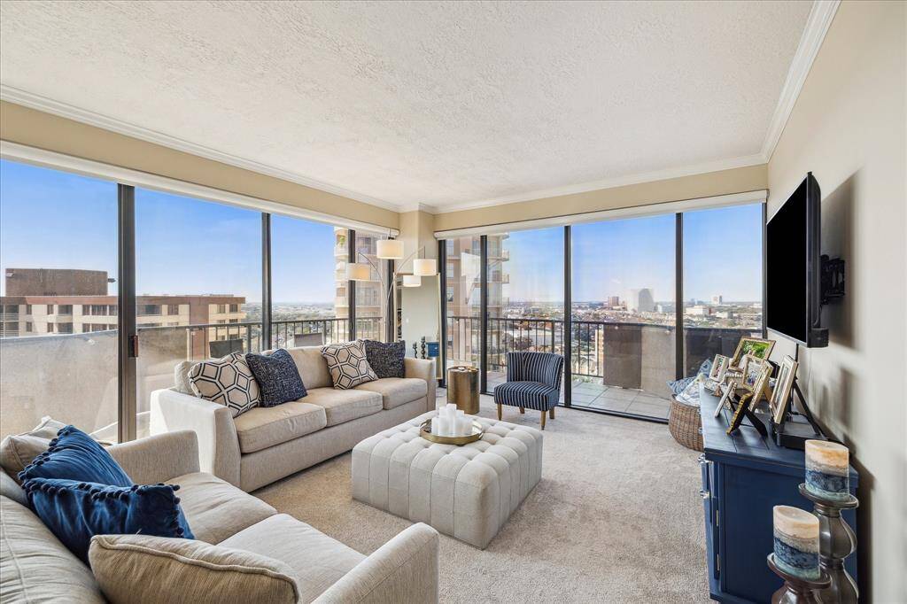 Living room features floor to ceiling windows ( throughout condo) and remote controlled window shades