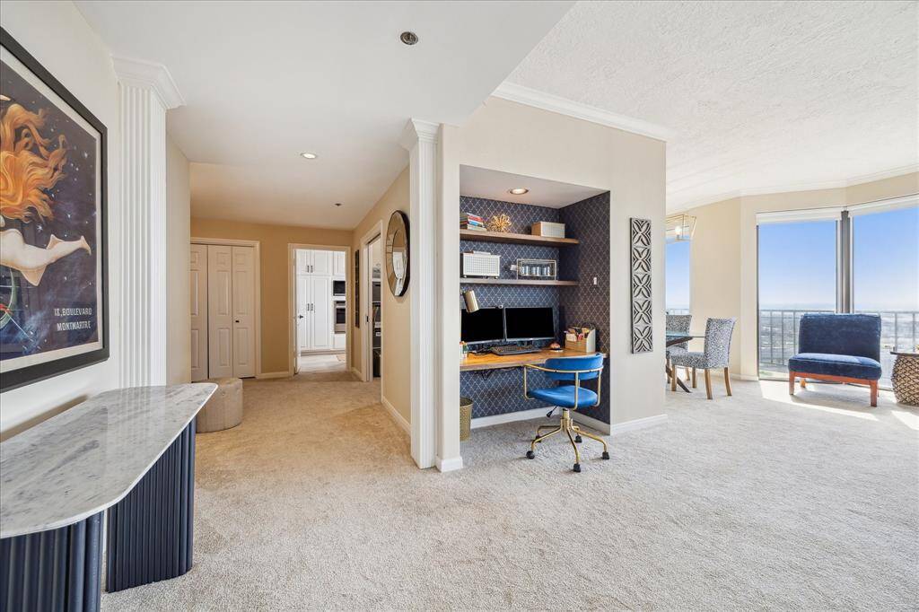 Owner is using this space as a desk area. It can be easily turned back into a wet bar area that is in the original floorplan or could be great space for bookcases, display shelving, etc..