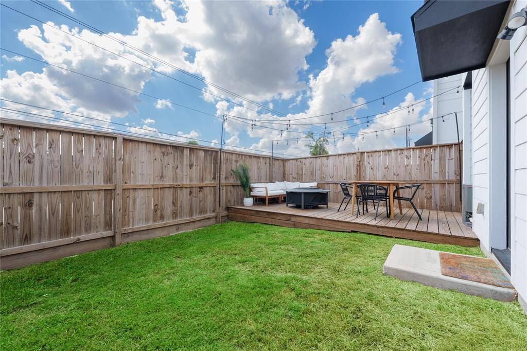Private fully fenced backyard with large deck.