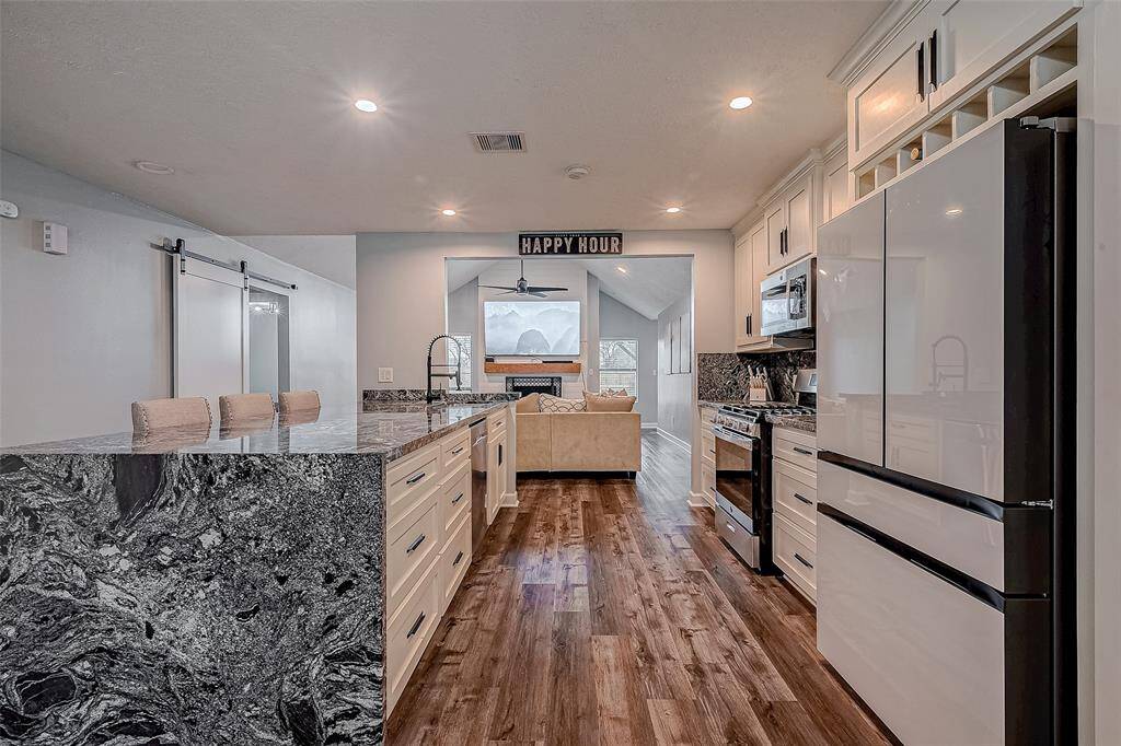 Kitchen with bar and gorgeous granite waterfall design.
