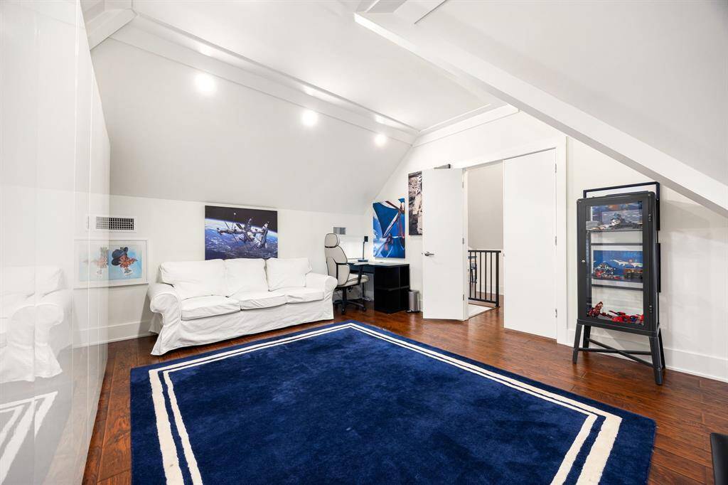 Expansive upstairs bedroom boasts vaulted ceilings and plenty of room for a bedroom set and more. A cozy nook within the room offers the perfect opportunity to create a separate sitting area, home office, or reading space—adding function and flexibility to this generously sized retreat.
