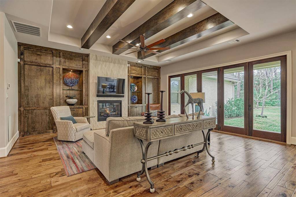 Living features wood beams, fireplace, and slider windows.