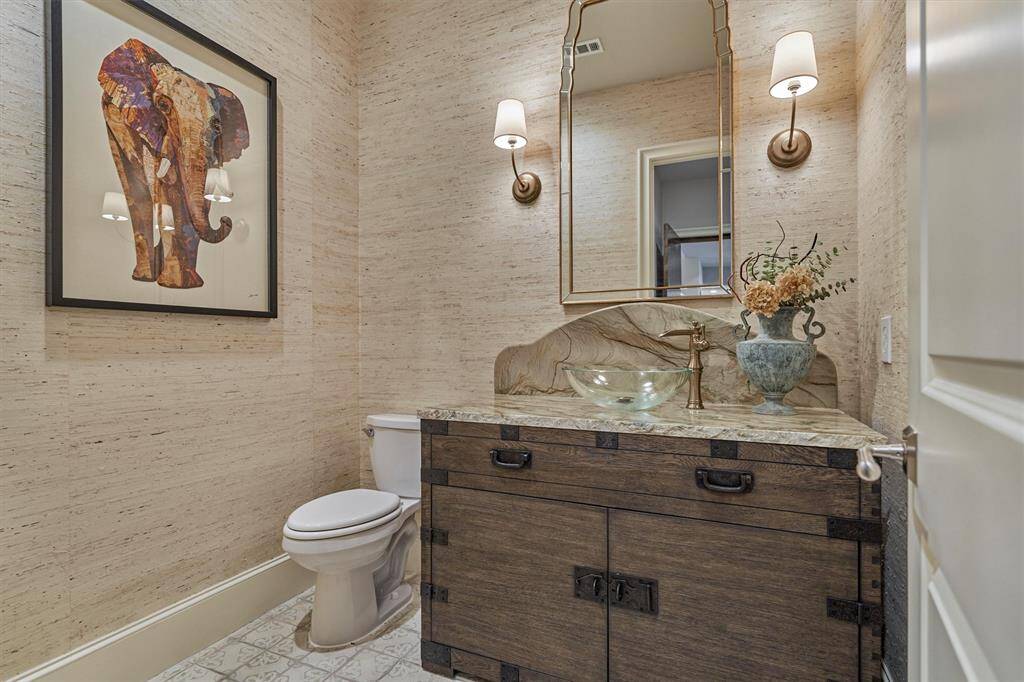 Powder Bath with custom sink and vanity. Grass cloth wallpaper and handmade floor tiles.
