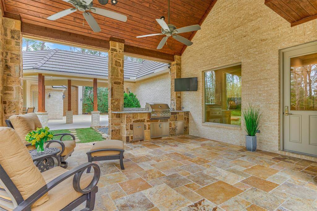 Summer kitchen complete with grill, sink and TV.