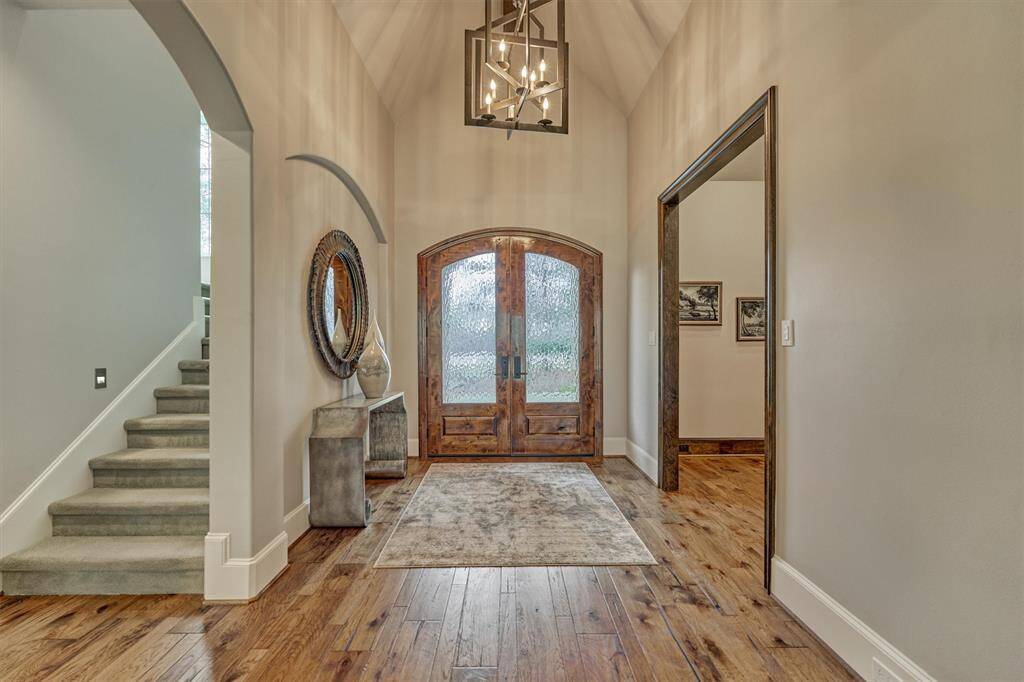 Spacious entry with high ceiling. Elegant wood floors throughout.