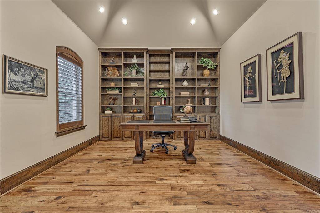 Elegant Home office/Study with built-in shelves. Murphy bookcase (center) opens to large storage closet.