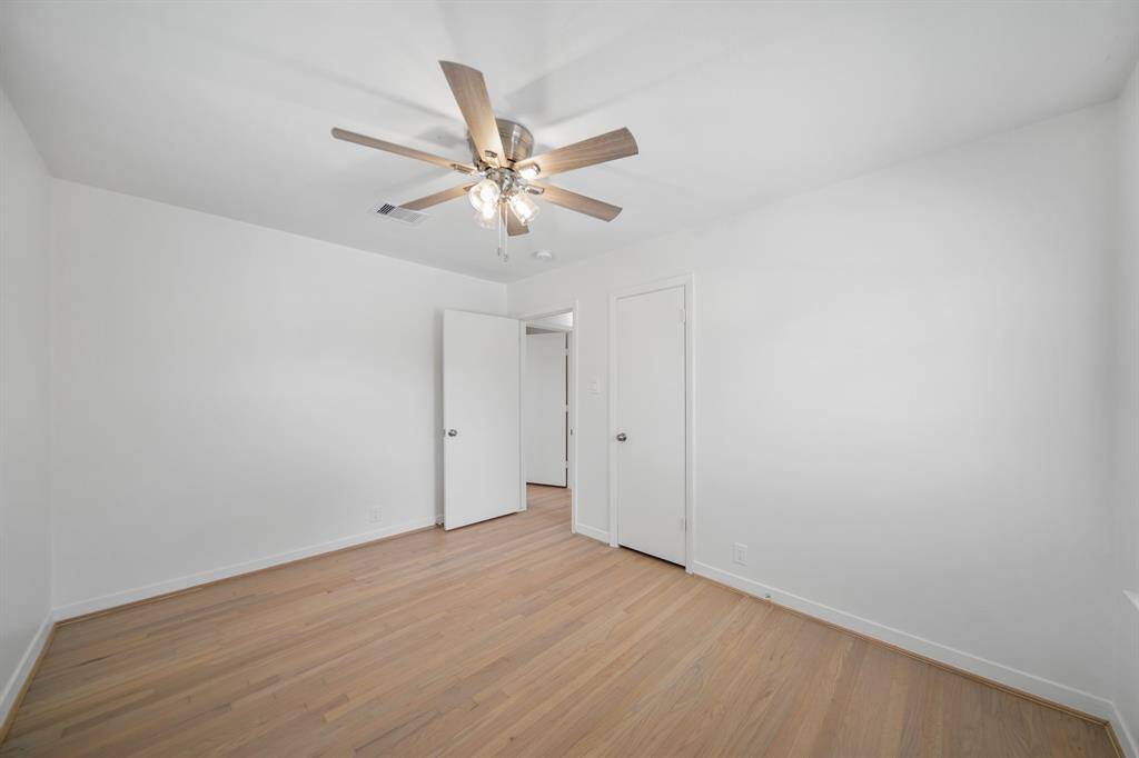 A view of the second bedroom with the corridor shown in the background.