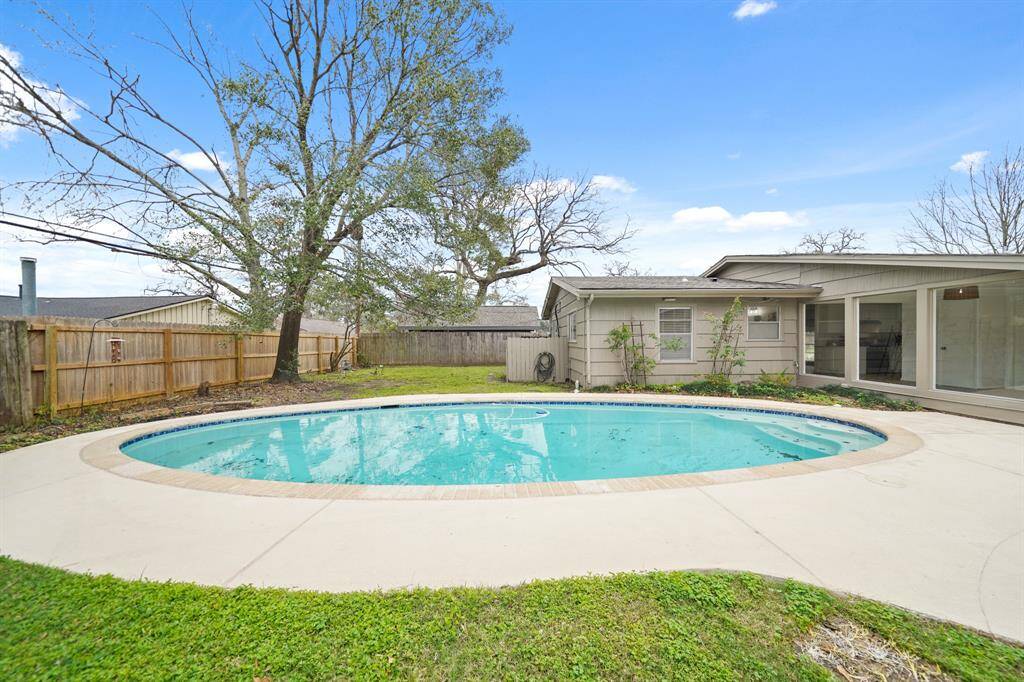 The in-ground swimming pool is surrounded by brick coping & tile accents. The swimming pool, decking & patio was resurfaced in 2024.