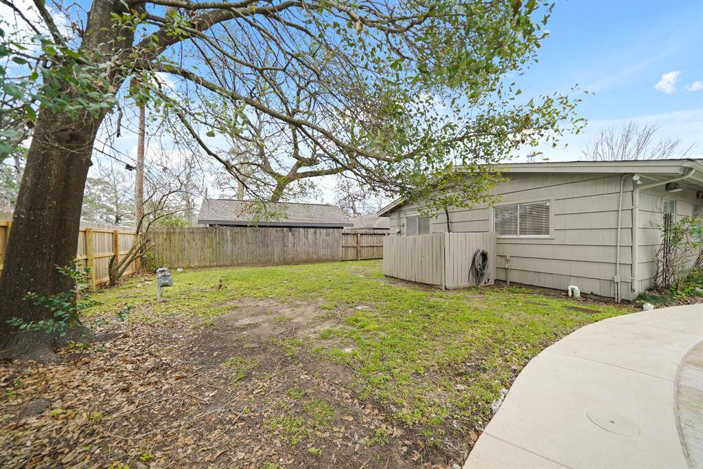 The backyard wraps around to a spacious side yard. Included are French drains and a rain gutters system with downspouts.