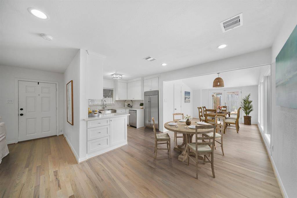 The breakfast room sits just between the living & dining rooms with convenient access to the kitchen. This photo has been virtually staged.