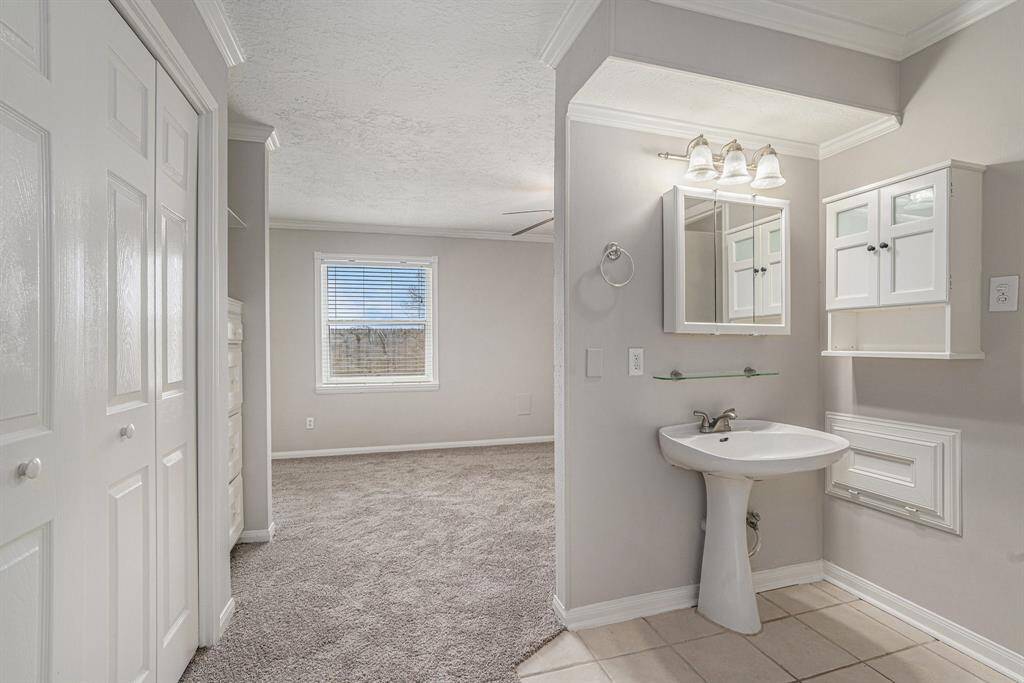 ANOTHER VIEW OF VANITY AND PRIMARY BEDROOM