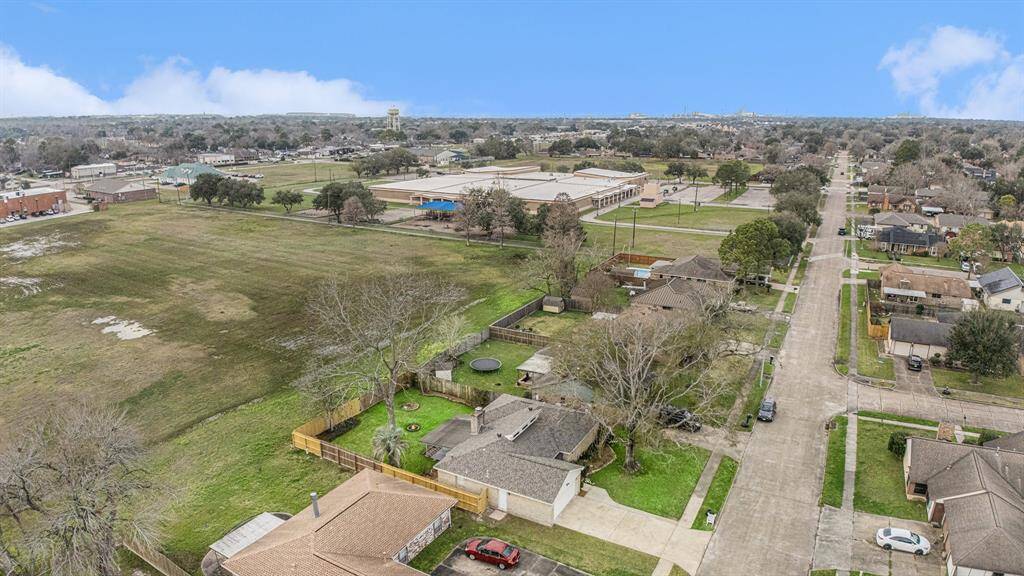 THIS SHOWS THE BACKYARD OF HOME WHICH BACKS UP TO A VACANT LOT BY SCHOOL