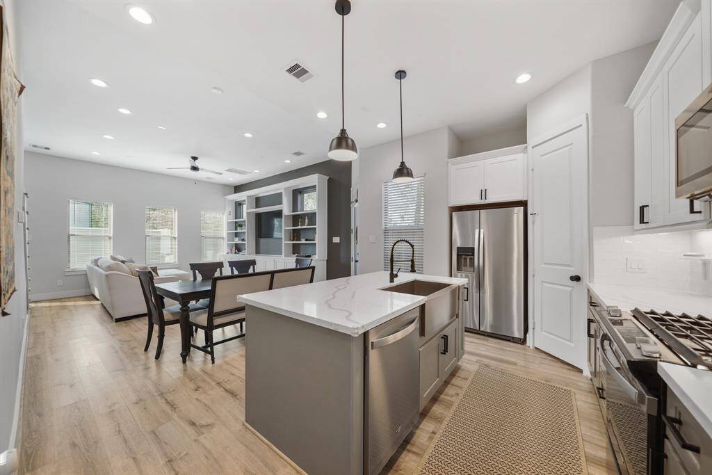 A view of the dining & living rooms from the back of the kitchen.