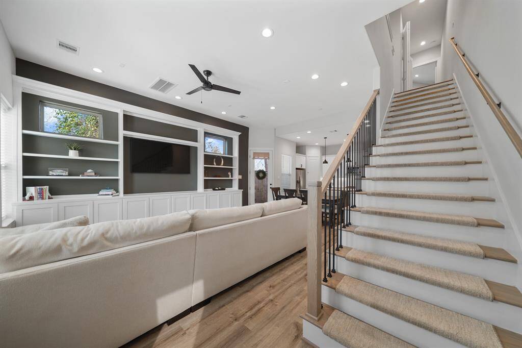 The staircase leads to the second level of the home with three bedrooms and two full baths.