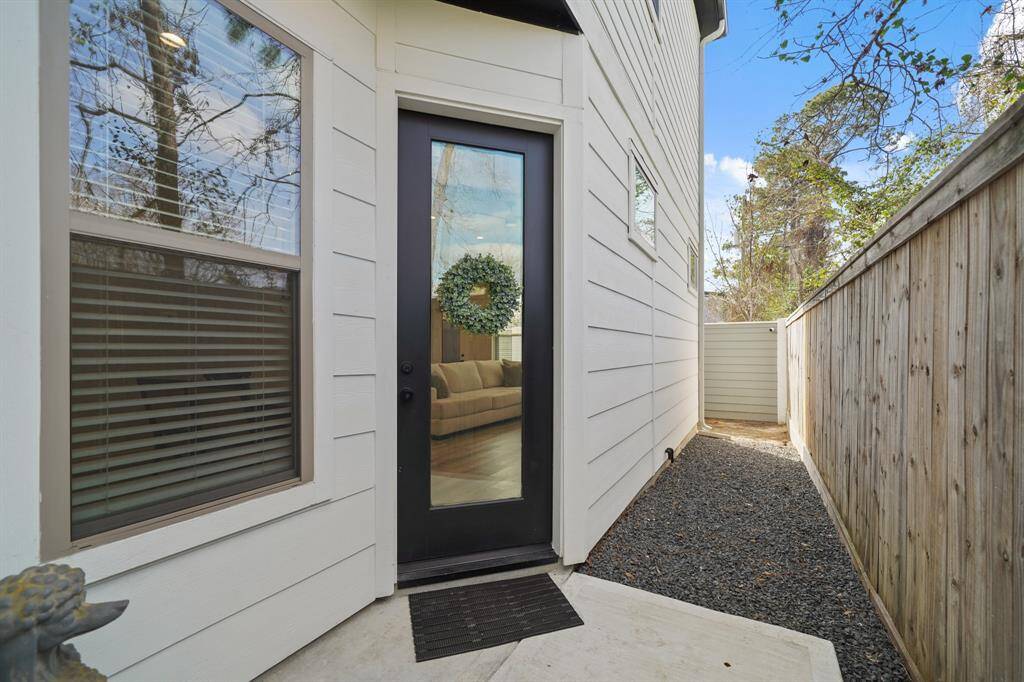 The welcoming front porch includes recessed lighting, glass entry door and a Ring video door bell. The crushed granite walkway continues to the fenced backyard.