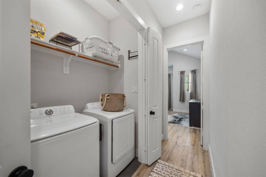 Tucked away behind bi-fold doors is the utility room with upper shelf storage, a hanging wardrobe storage rod & tile flooring. The Samsung full-size washer & dryer stays with the home.