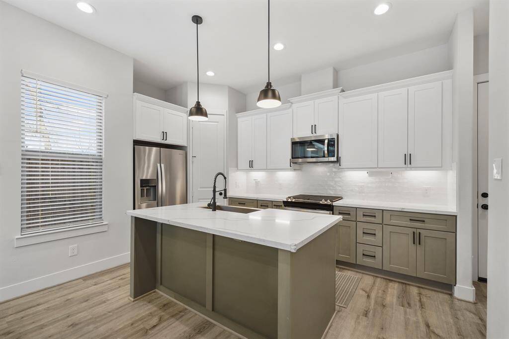 The Whirlpool stainless steel appliance package includes a 4-burner gas range with conventional oven below, built-in microwave oven with ventilation & lighting above and a dishwasher. As an added bonus, the stainless steel side-by-side refrigerator/freezer with door mounted ice & water dispenser remains with the home.