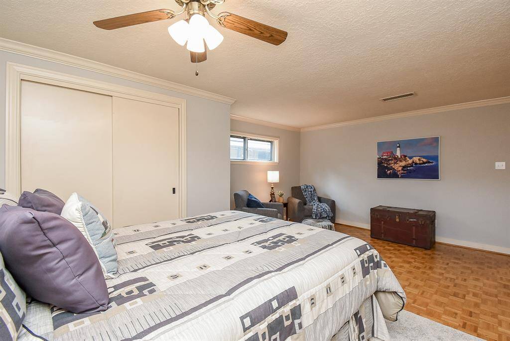 The bedroom offers ample space for a king-sized bed and additional furniture. The ceiling fan ensures comfort, while the soft color palette promotes a tranquil atmosphere. The built-in closet provides generous storage, keeping the room tidy and organized.