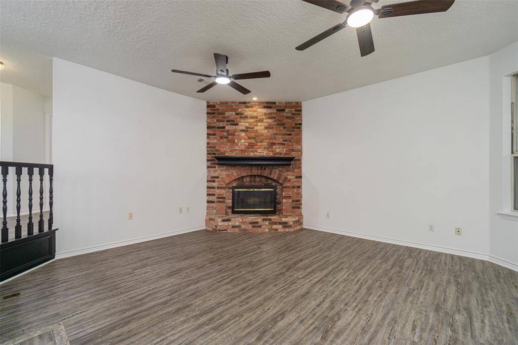 The super cool sunken living room sits on the waterside with a lot of windows. The corner gas fireplace just sends out cozy vibes. Luxury vinyl plank flooring has been recently installed throughout the home