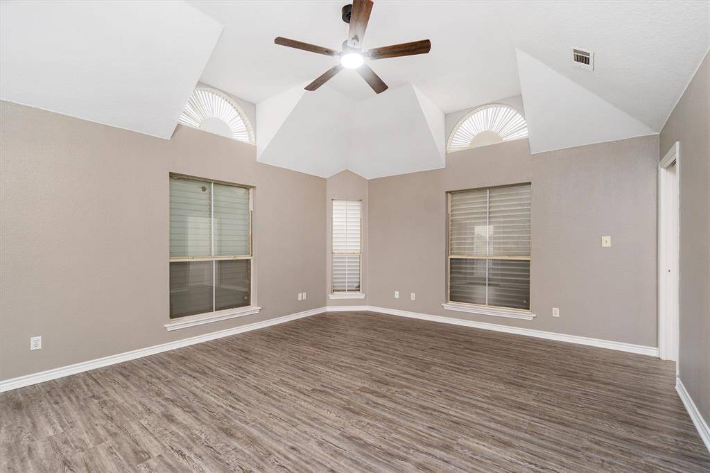 The primary bedroom is large and can hold a lot of furniture. Notice the unique ceiling