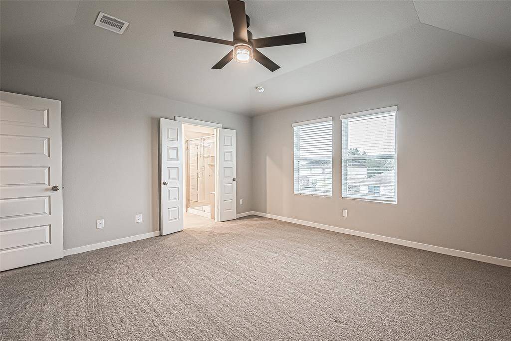 The primary bedroom and ensuite bath are situated on the back side of the house and are separated from the other bedrooms to provide privacy.