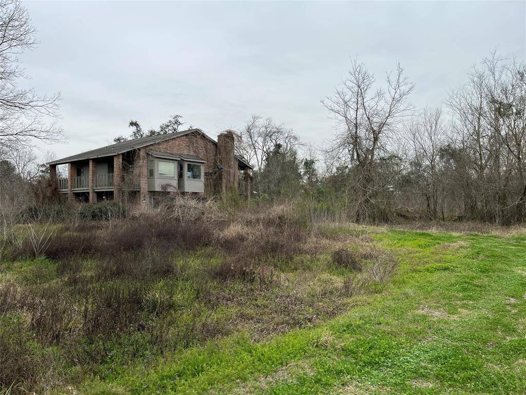 We're nearing the back of the property. The driveway curves to the old house that was flooded in Harvey.