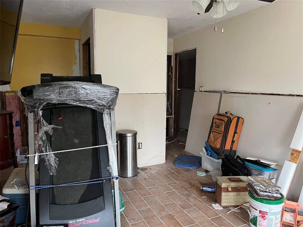 Downstairs. You can see some sheetrock was replaced and there are tile floors.
