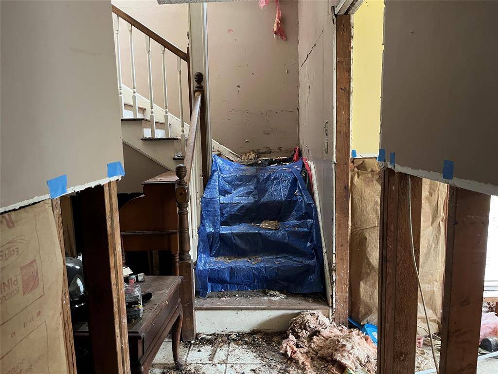 The stairs lead up to the main living area. There has been a roof leak here.