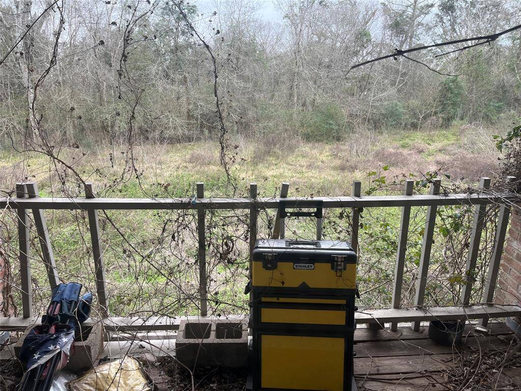 This is a view toward the Chocolate Bayou from the upper balcony off the living room. It can be a beautiful property when it's cleaned up.