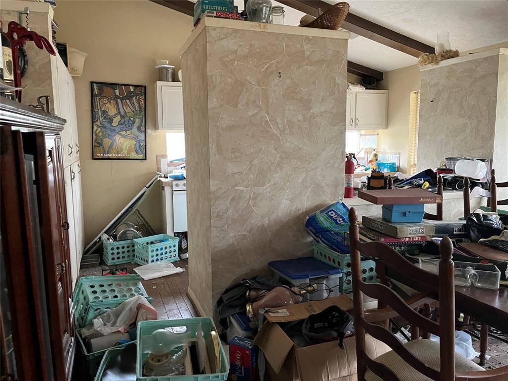 The kitchen is beyond the dining room.