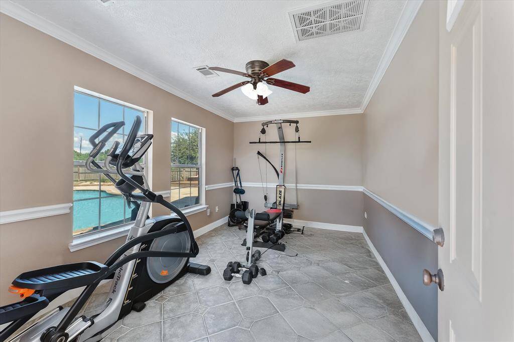 Workout room or office by pool area