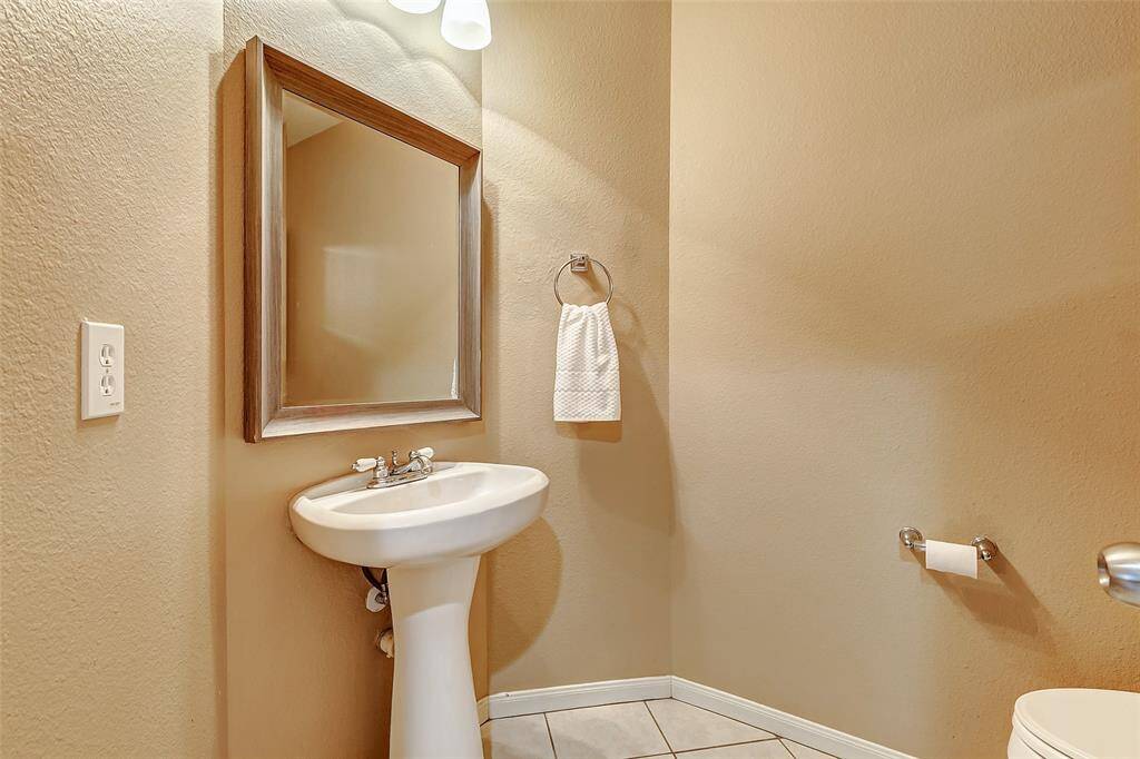 The half-bath is conveniently located in the main hallway for guests.