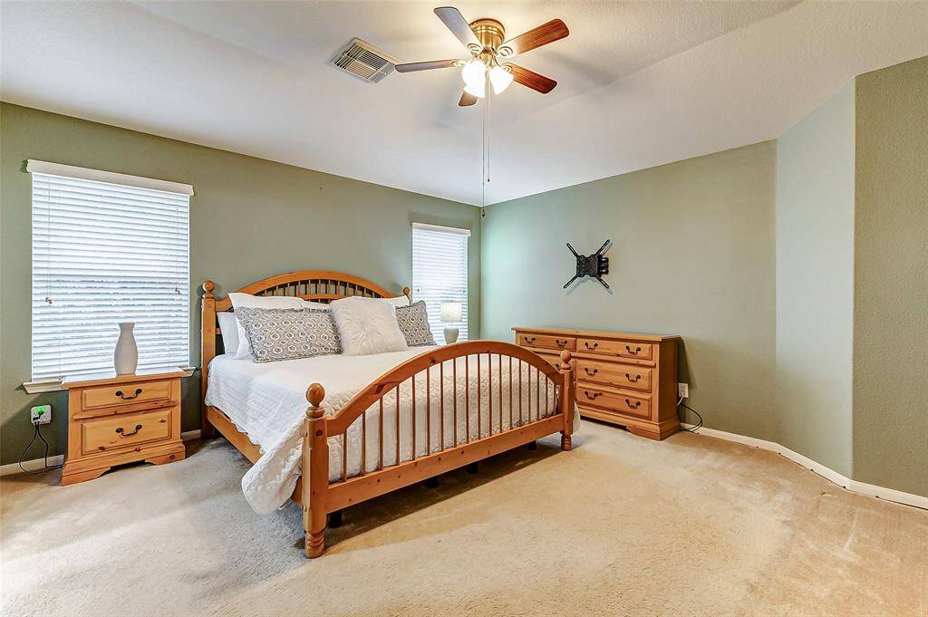 The primary bedroom suite is located at the top of the stairs, to the left.