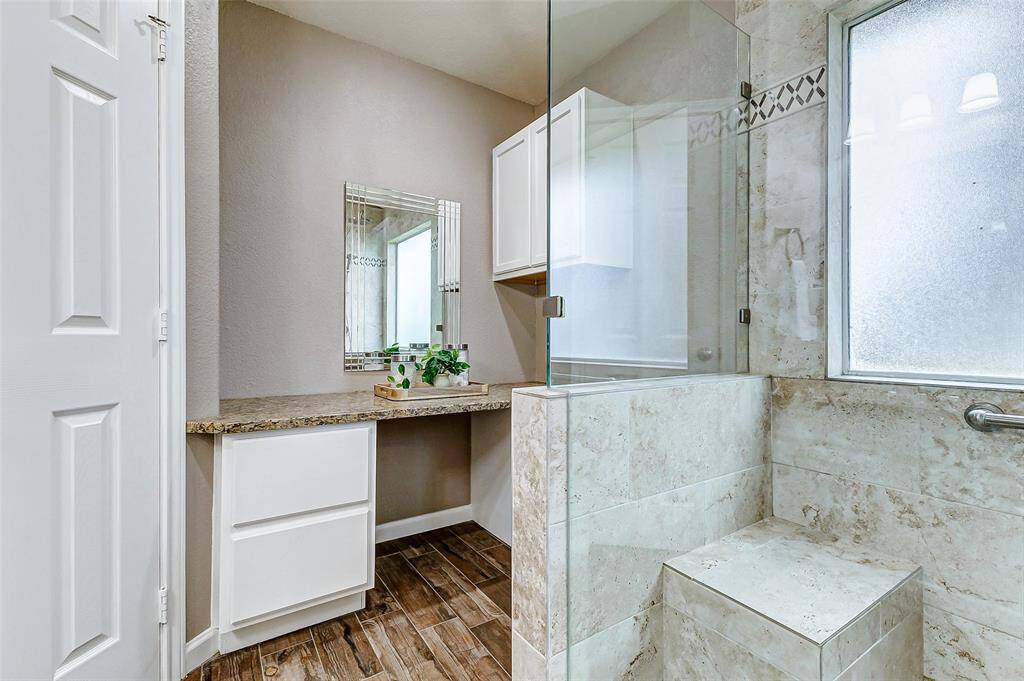 The primary bedroom also has a vanity area tucked behind the shower.