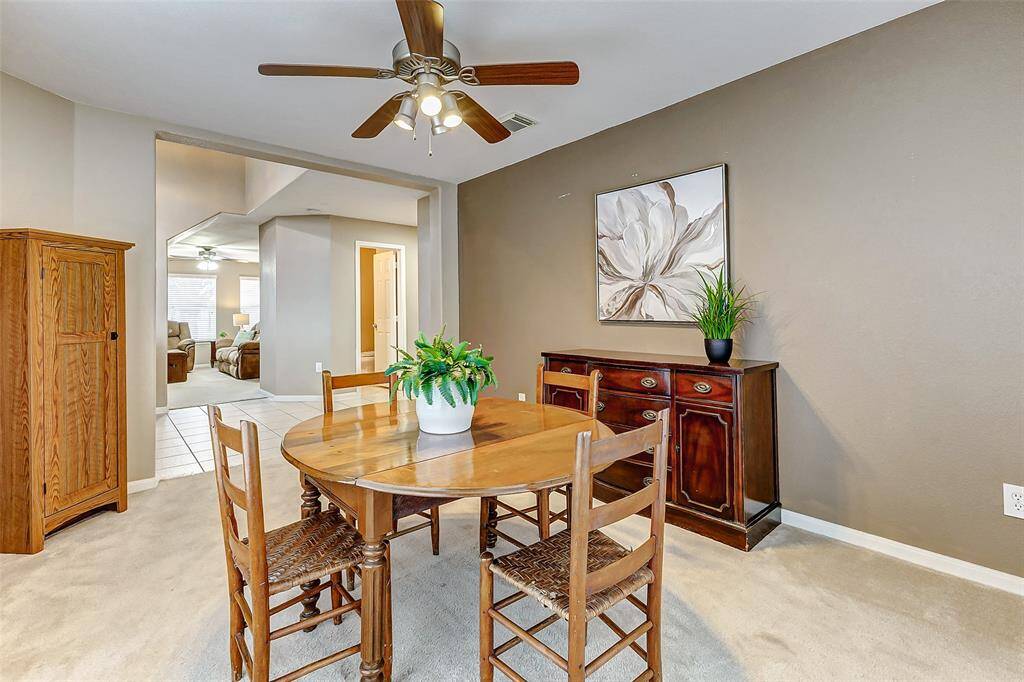 The dining room is open to the entry and is flanked by large windows to bring in the natural light.