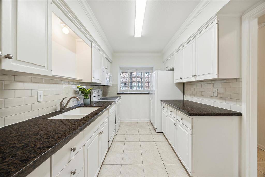 The gallery style kitchen includes all appliances to transfer with the sale of the home.