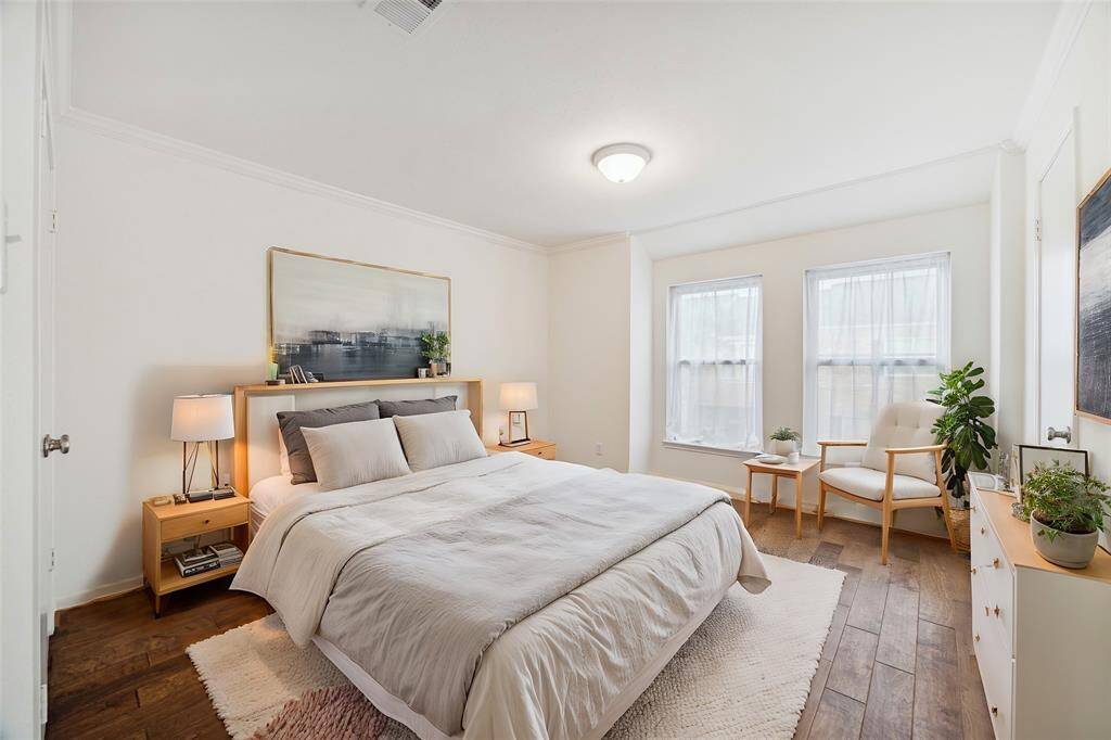 Primary bedroom overlooks the courtyard. *Virtually staged*