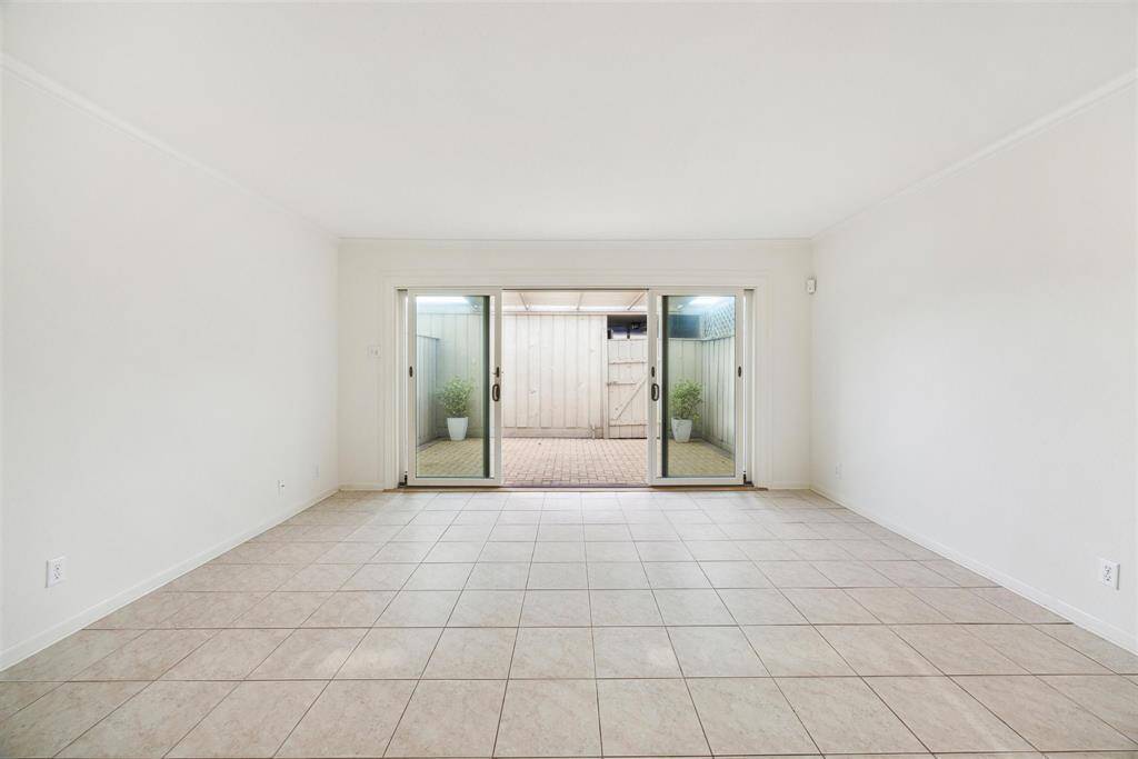 An open living room boasts natural light from the expansive sliding doors.