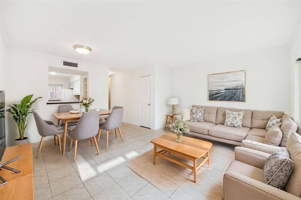 The living area also provides a designated space for dining complete with light fixture. *Virtually staged*