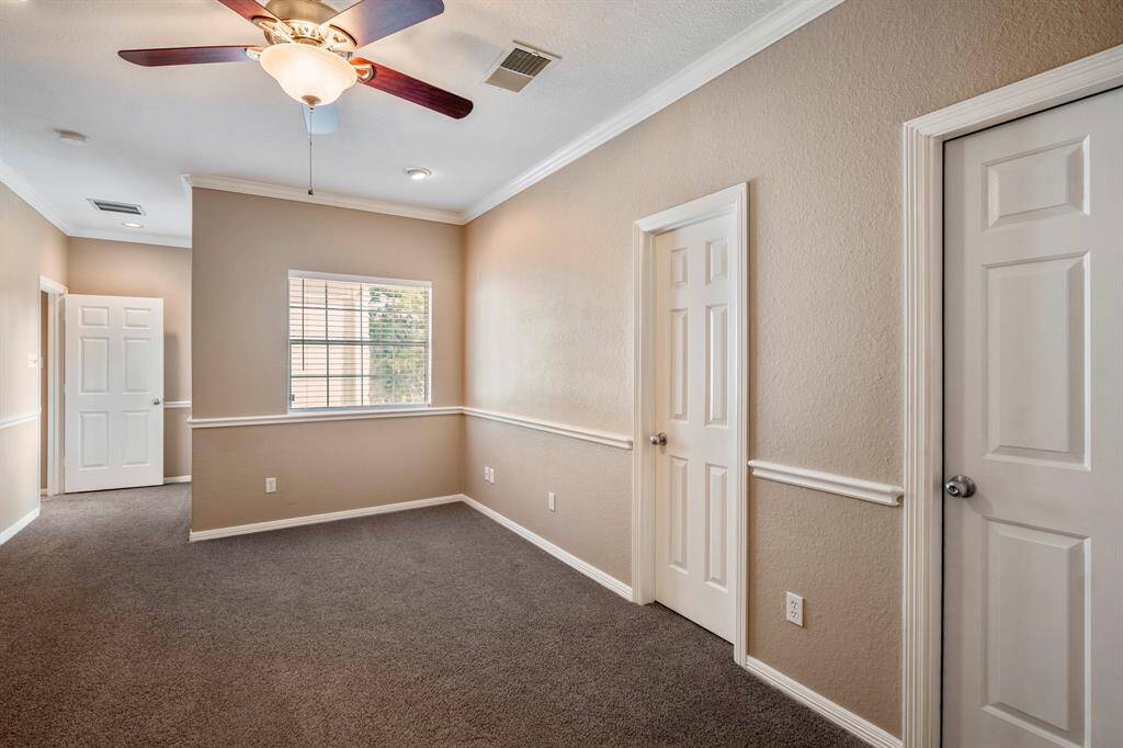 This unique bedroom is tucked away at the front of the house, behind the built-in study nook area. It features a large walk-in closet and offers convenient attic access. The room is bright and airy, with large windows that overlook the second entrance to the home, adding a sense of privacy and tranquility.