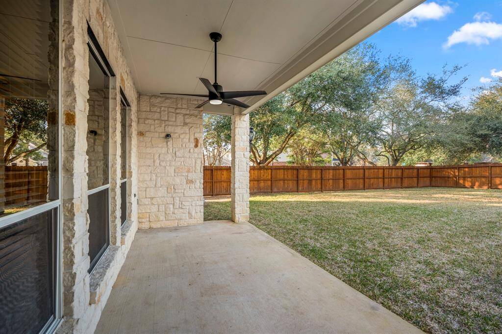 Stepping out the back door onto the porch, you’re greeted with a peaceful view of the spacious backyard. This outdoor area offers a perfect space for relaxing, entertaining, or enjoying the fresh air.