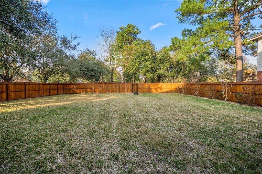 The backyard is fully enclosed with a cedar privacy fence, freshly stained in 2024. At the back, a gate opens to the pocket park behind the home, offering easy access to green space and a tranquil setting just steps away from your doorstep.