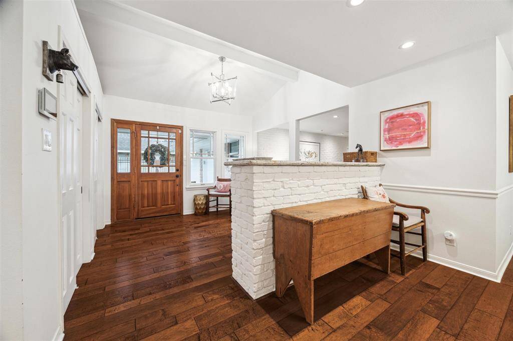 A brick pony wall adds character while providing nice separation from the foyer.