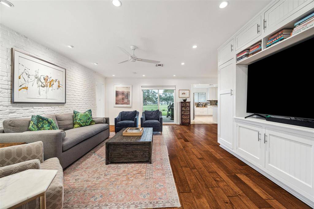 Imagine a seamless indoor-outdoor lifestyle in this expansive living room that opens directly to the large, park-facing backyard.