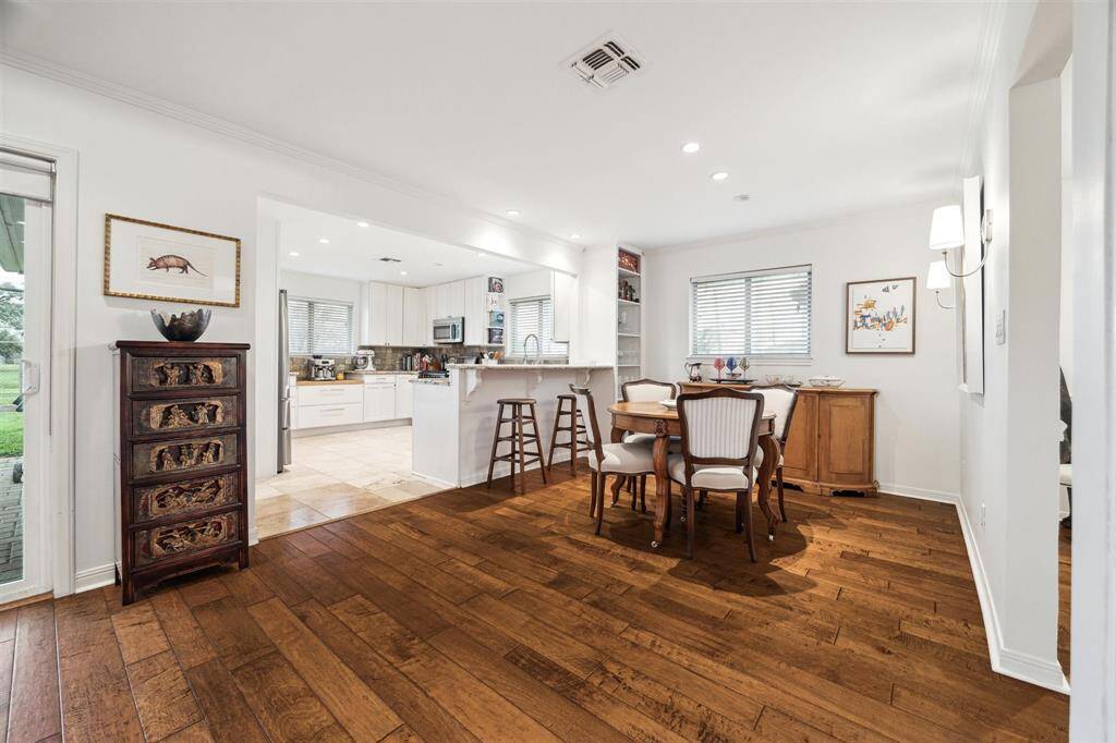 Upgraded sconces, a built-in bookcase and crown molding trim the breakfast room, while a dining counter adds even more space for casual dining and gathering.
