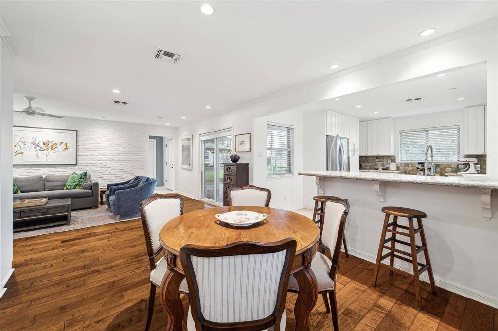 Throughout this sun-kissed home, large windows are trimmed with custom blinds.